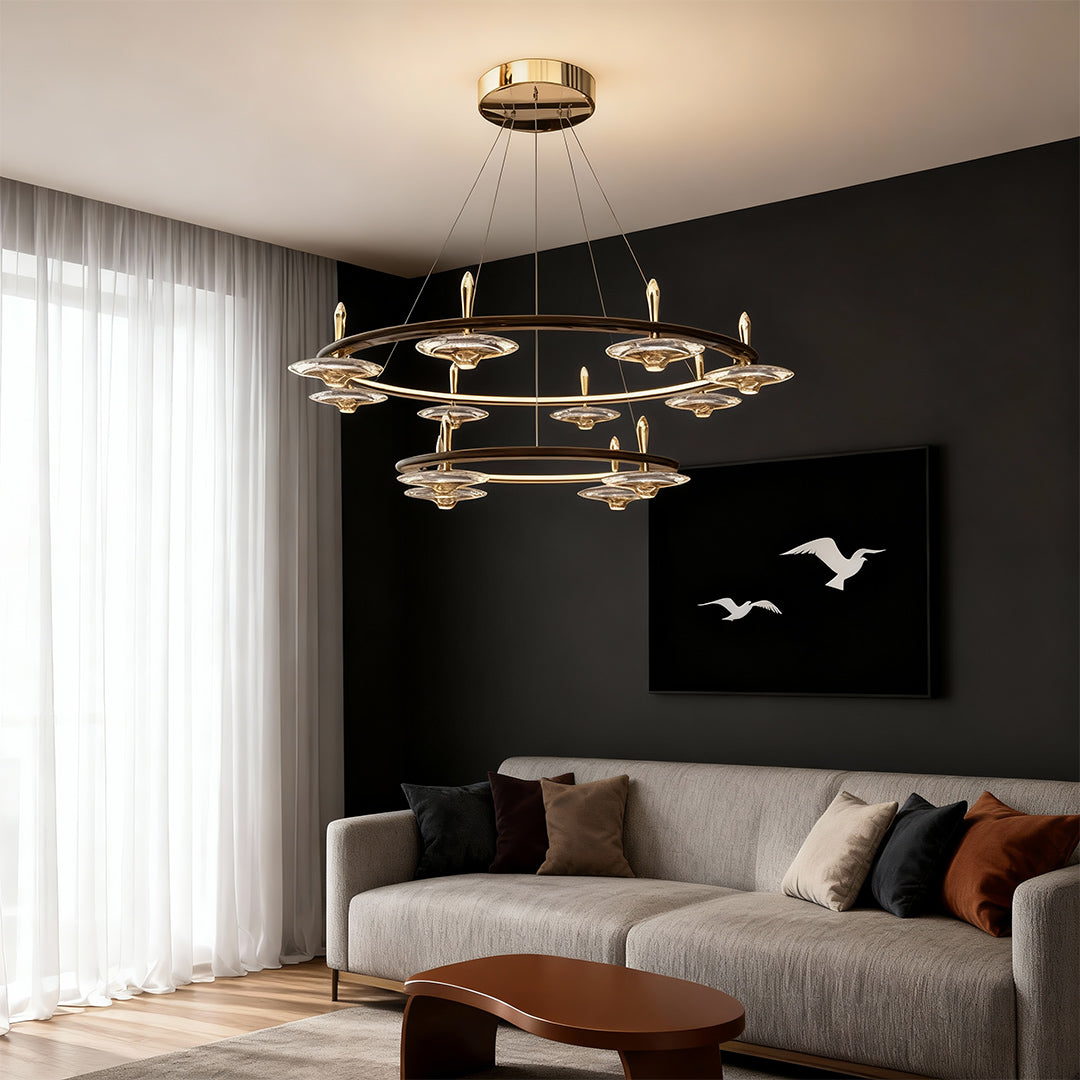 Chandelier with round crystals suspended in modern bedroom with black accent wall and neutral furnishings