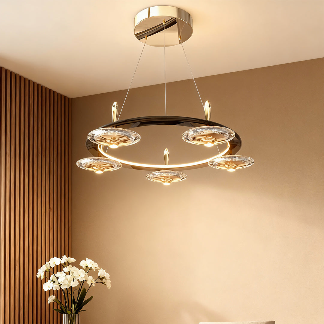 Chandelier with round crystals illuminating warm-toned dining space with wood paneling and contemporary interior design