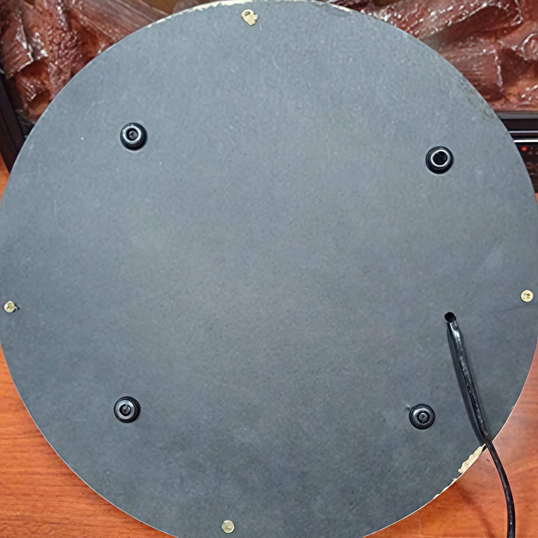 Back view of a charcoal burner lighter showing its round base and installation.