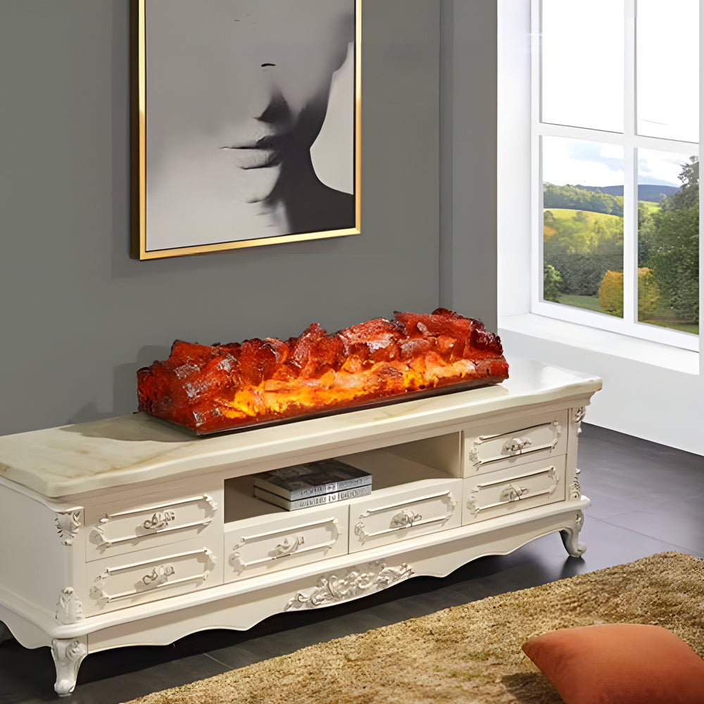 Charcoal burner lighter with a decorative flame design, placed on a white cabinet.