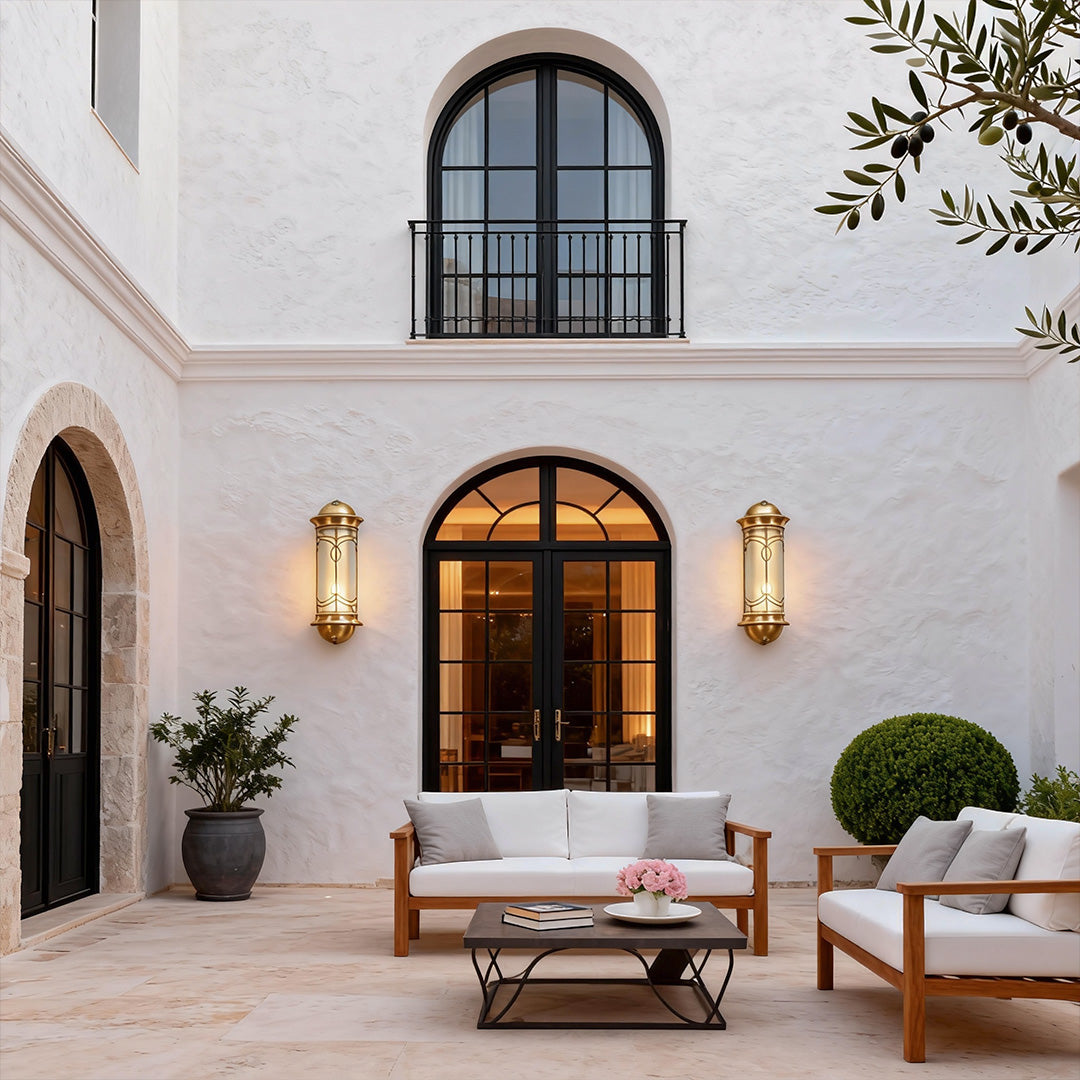 Charming copper outdoor wall sconce on a stone wall, perfect for creating a cozy and elegant outdoor atmosphere.