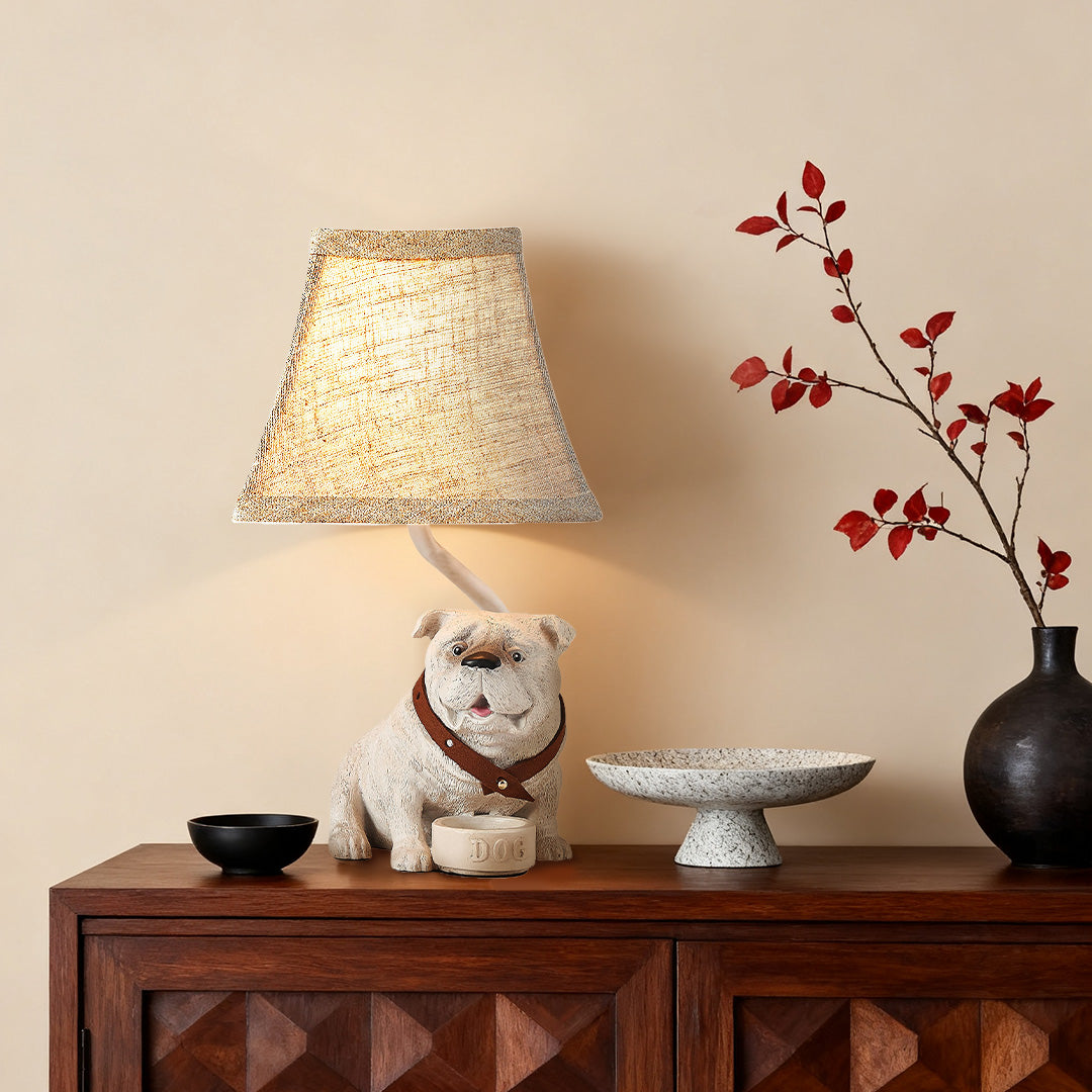 Charming dog table lamps highlighting the detailed sculpture base and a woven conical shade on a dark wood console.