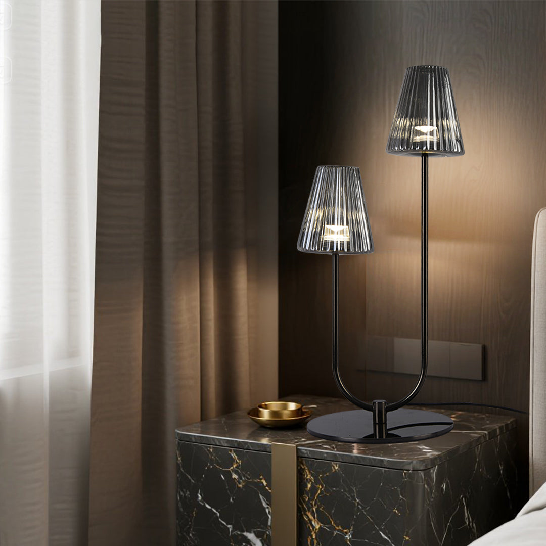 Chic dual-head elegant table lamps with ribbed glass shades on a luxury marble nightstand set.