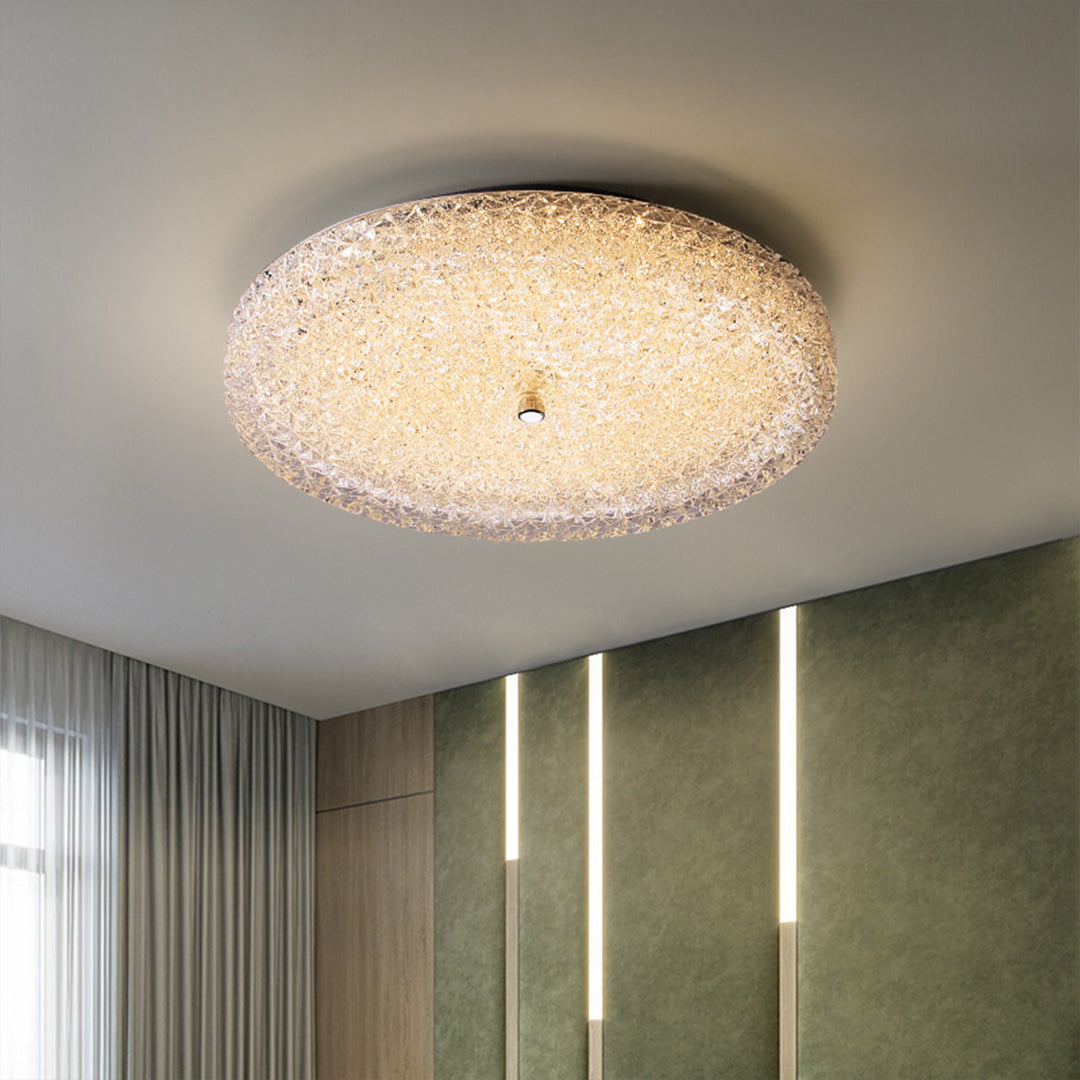 Stunning flush mount crystal ceiling light glowing warmly in a chic modern green hallway space.