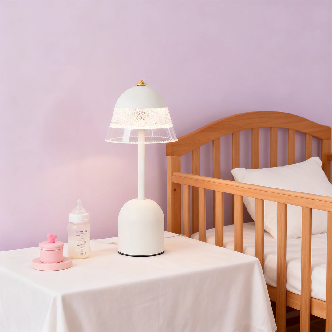 Child-safe white USB table lamps on a nursery table next to a crib, perfect for soft nighttime illumination.