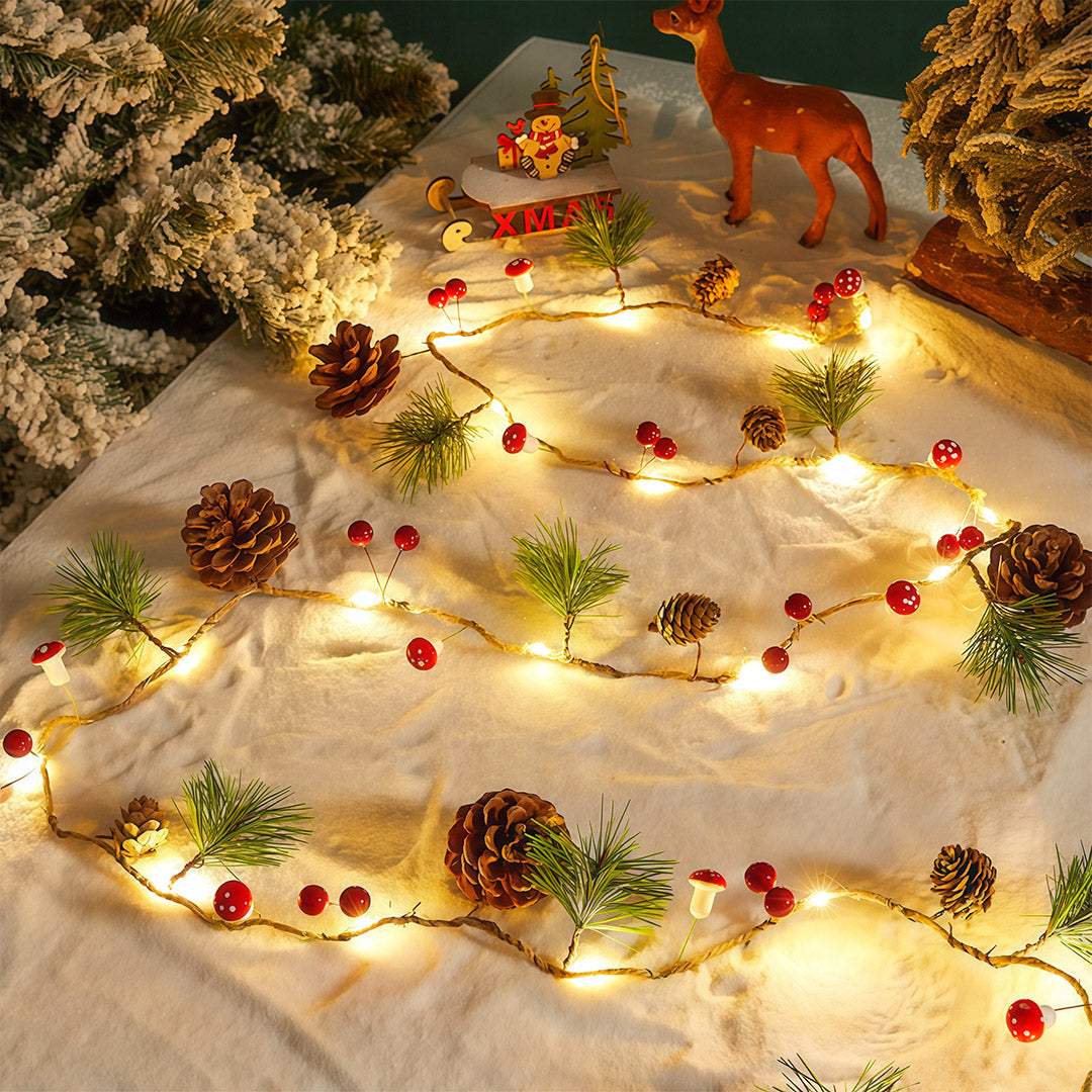 Christmas LED string lights displayed on a snow-like surface with pinecones and warm white glow.