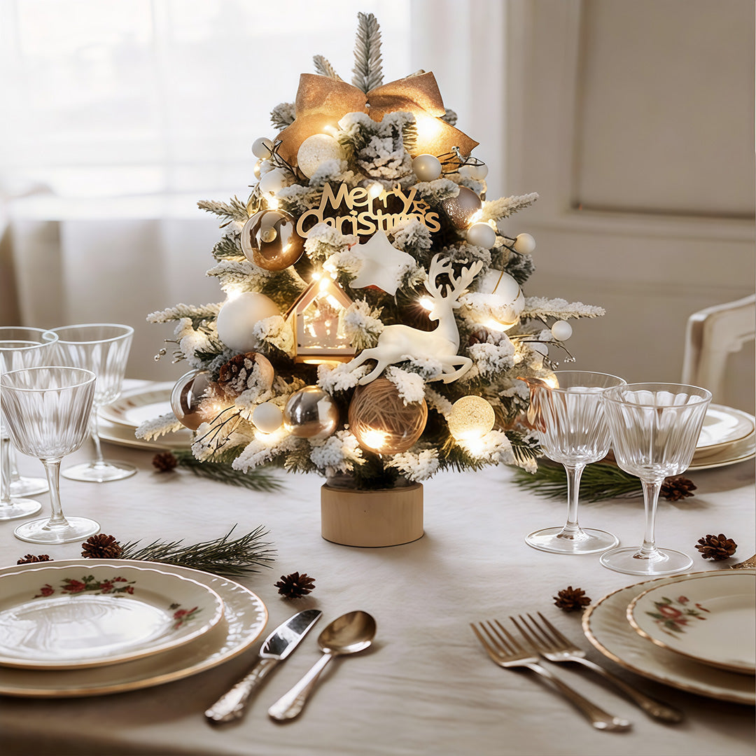 Christmas tree table lamp providing soft light beside a holiday table setting.