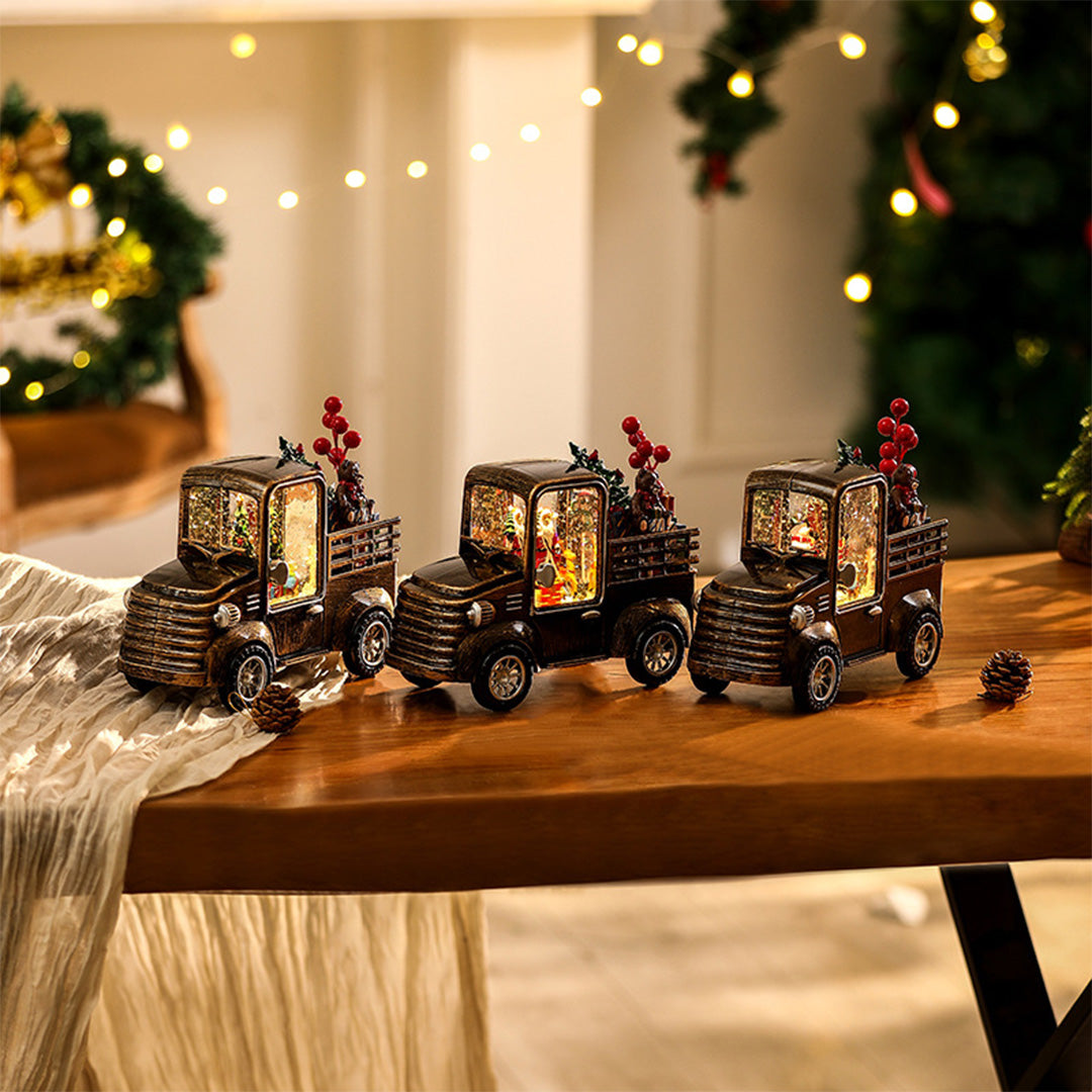 Illuminated Christmas trucks displayed on a wooden tabletop, radiating soft modern gold table lamp lighting.