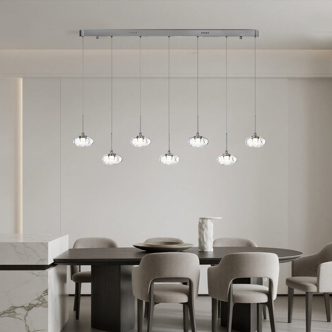 Contemporary multi light pendant lighting with chrome finish displaying glass globe arrangement in modern conference space