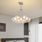 Multi light chandelier with chrome finish displaying multiple glass spheres in contemporary home environment
