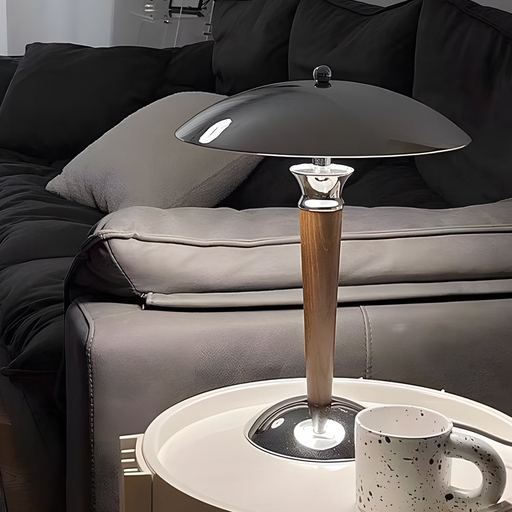 Chrome mushroom lamp on a bedside table, providing soft lighting for a comfortable bedroom setting.