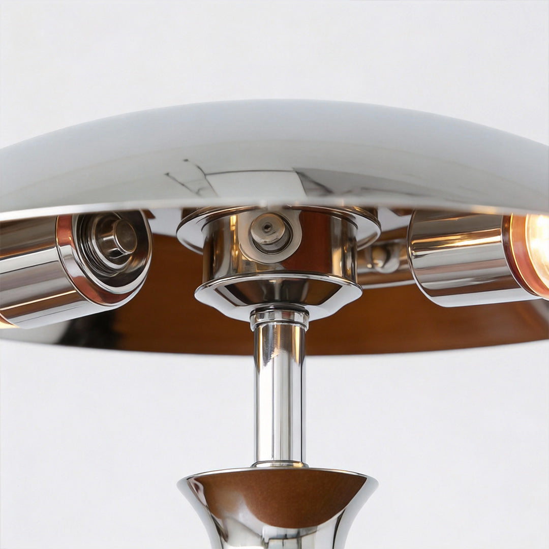 Underside view of chrome mushroom lamp, highlighting the reflective metallic interior and sturdy base.