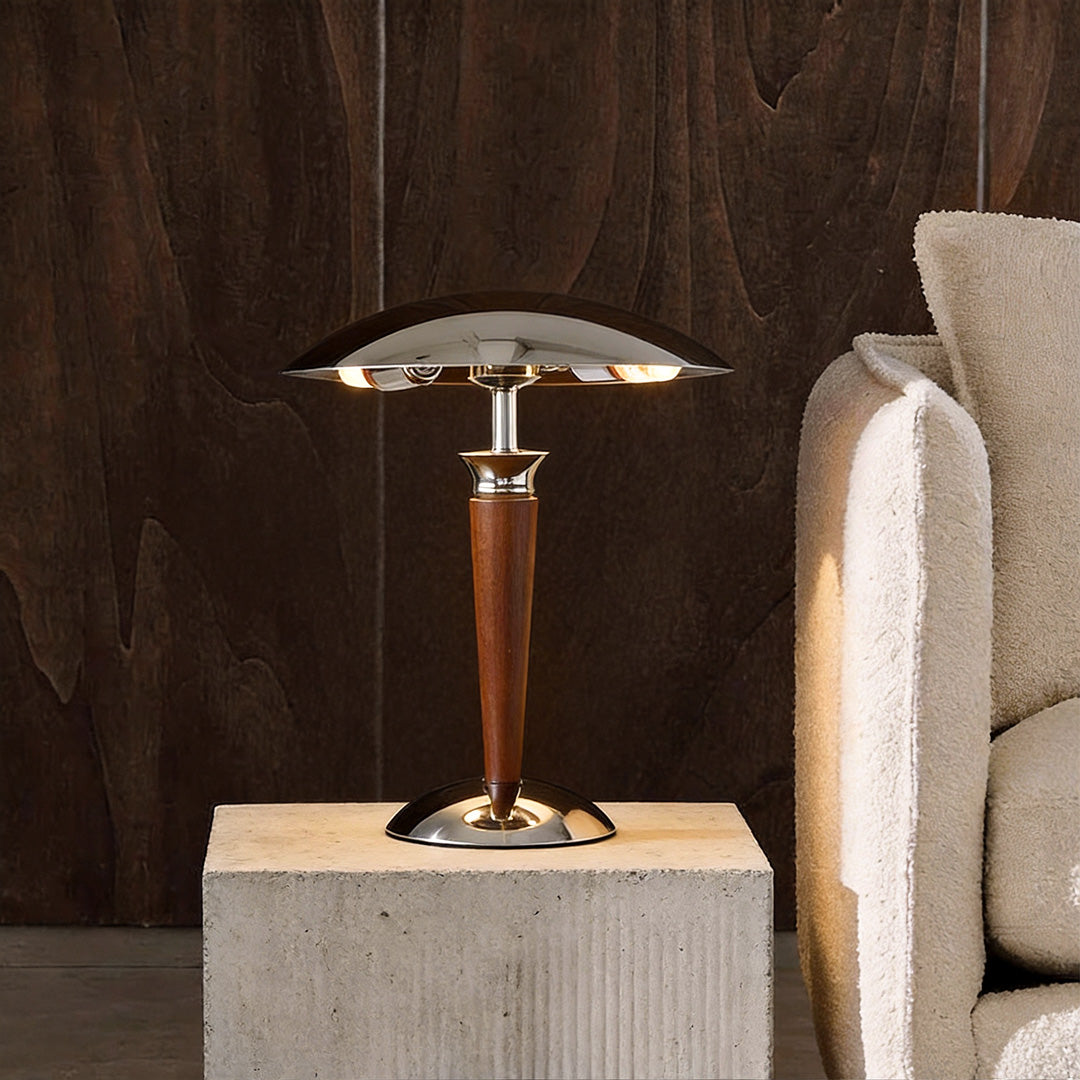 Elegant chrome mushroom lamp with wooden base and metallic shade in a cozy living room corner.