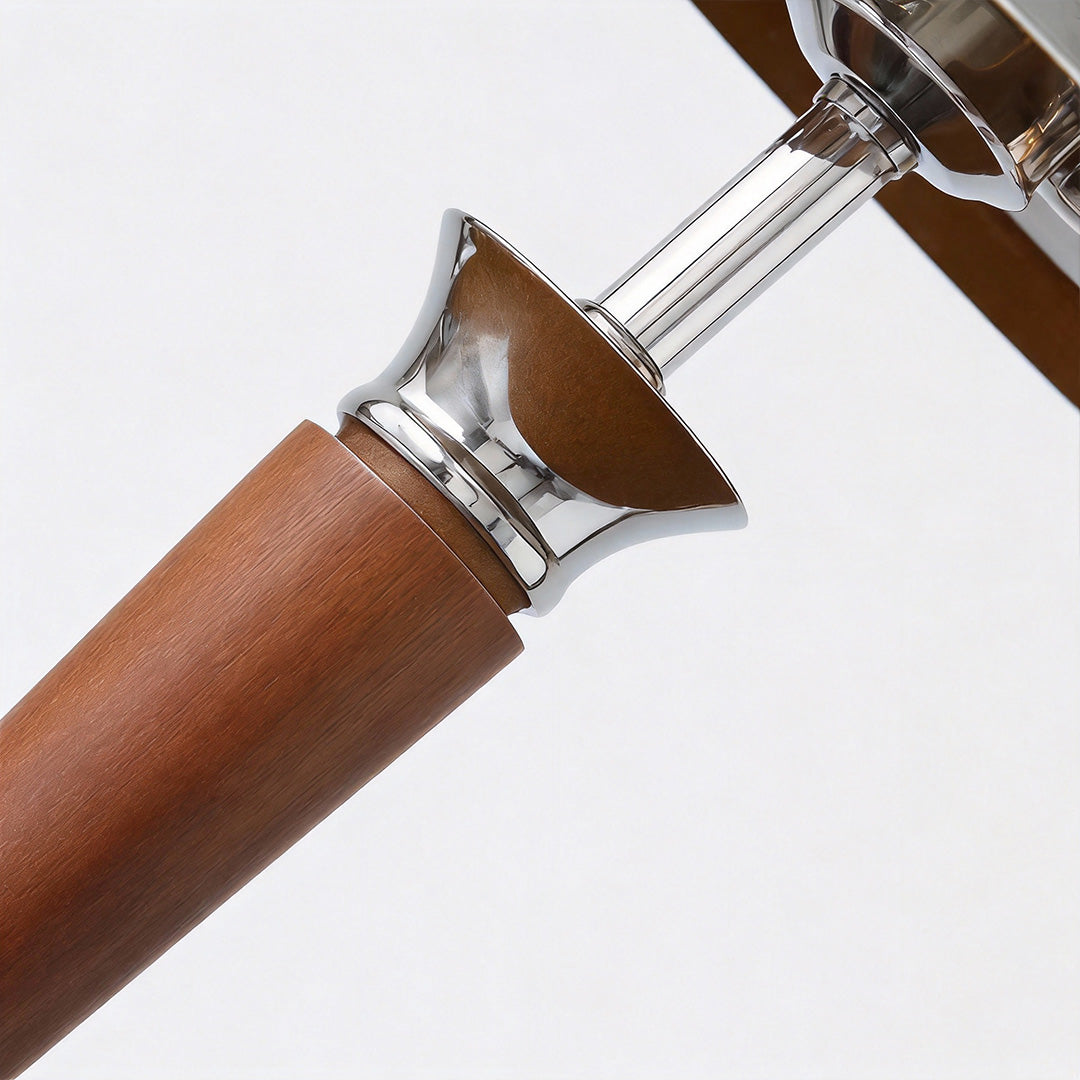 Close-up of chrome mushroom lamp's wooden handle and metallic joint, showcasing craftsmanship details.