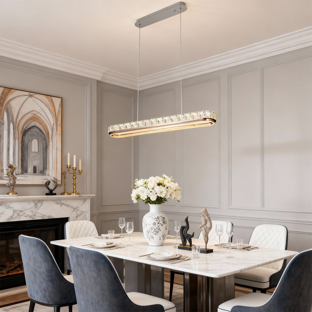 Chrome pendant light in a modern interior with a white and gold theme, offering a stylish focal point.