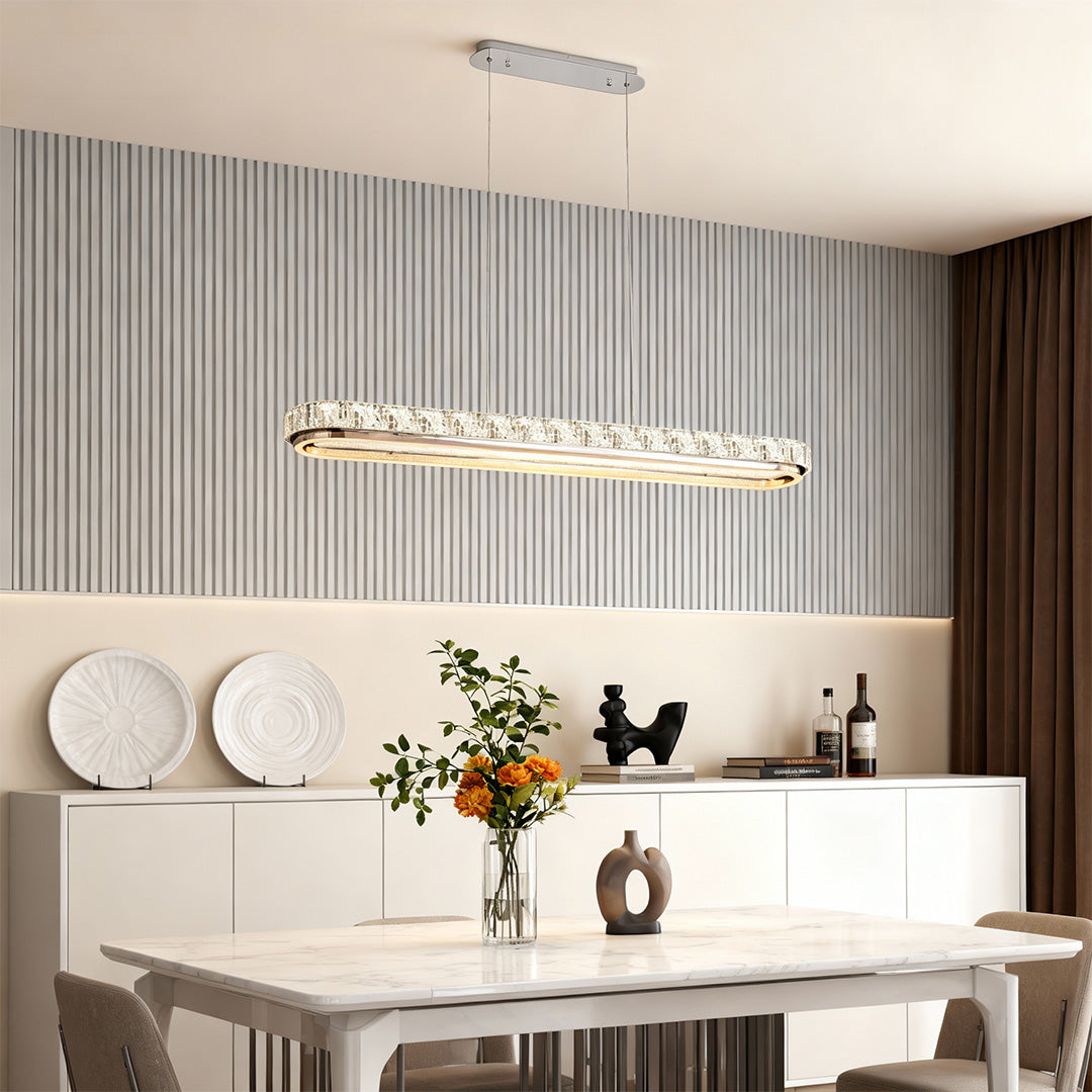 Chrome pendant light in a stylish dining room with cream chairs, creating a sophisticated atmosphere.