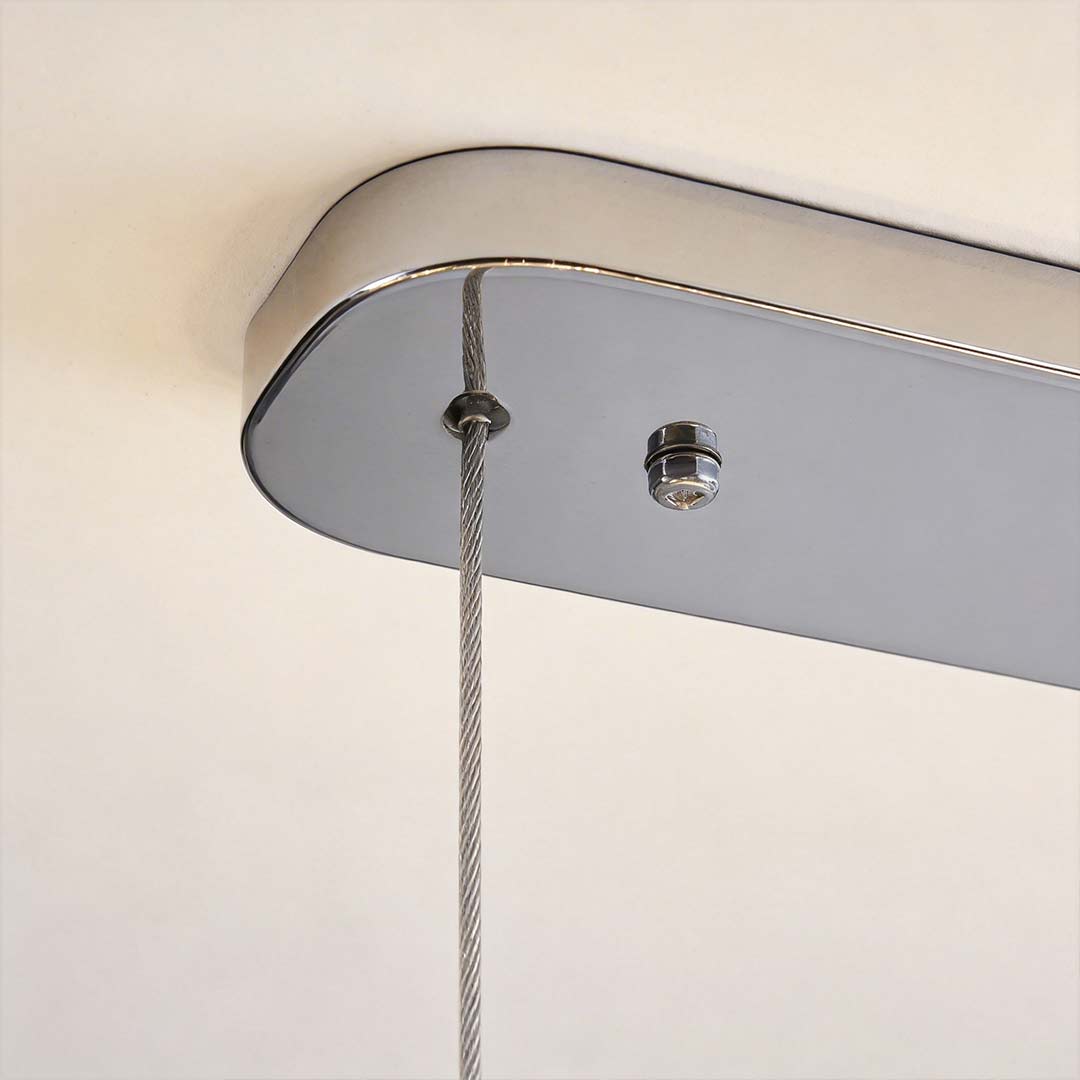 Chrome pendant lights with a close-up of their illuminated crystal and chrome design.