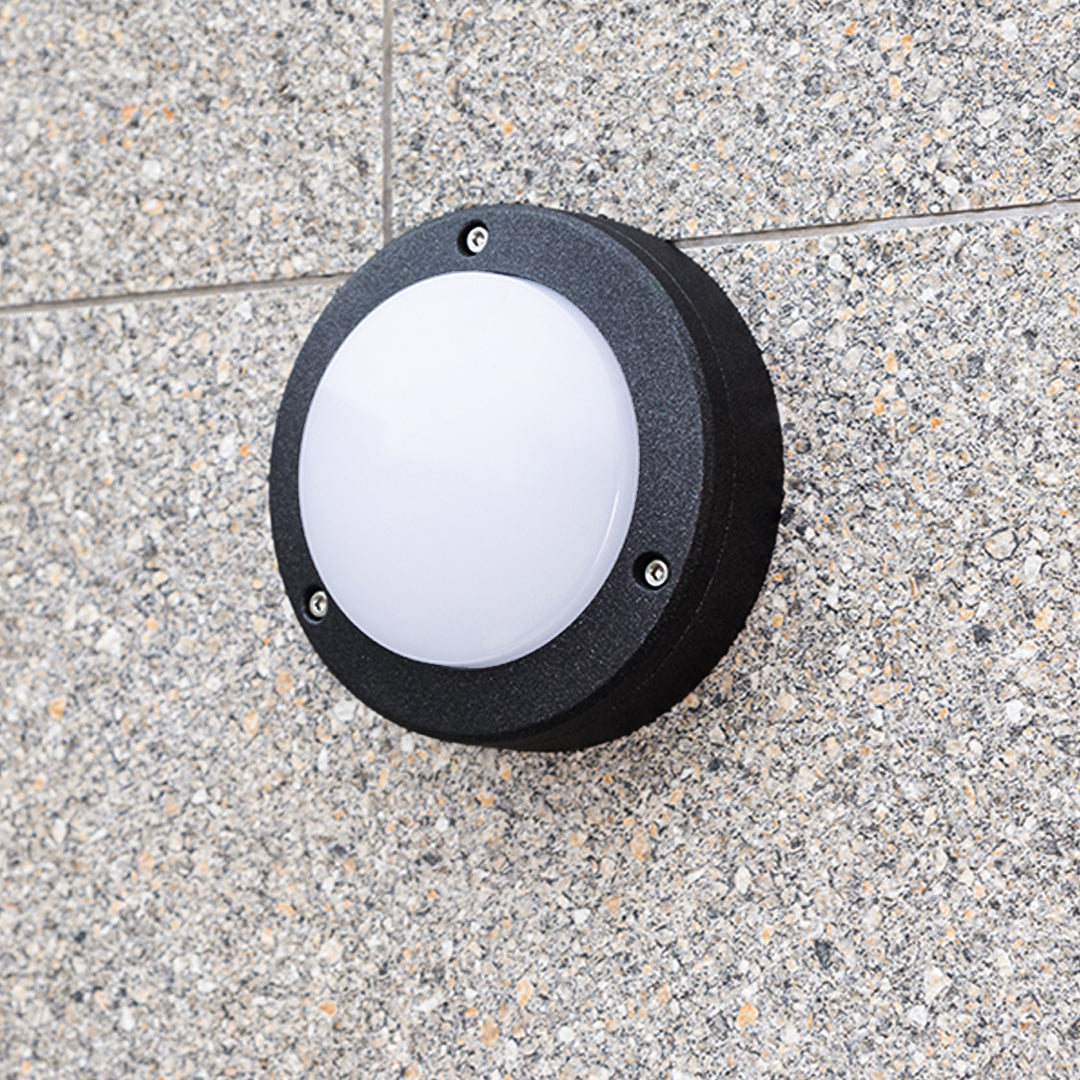 Detail shot showcasing the thick circular bezel and rough surface finish of the exterior round outdoor wall lights fixture.