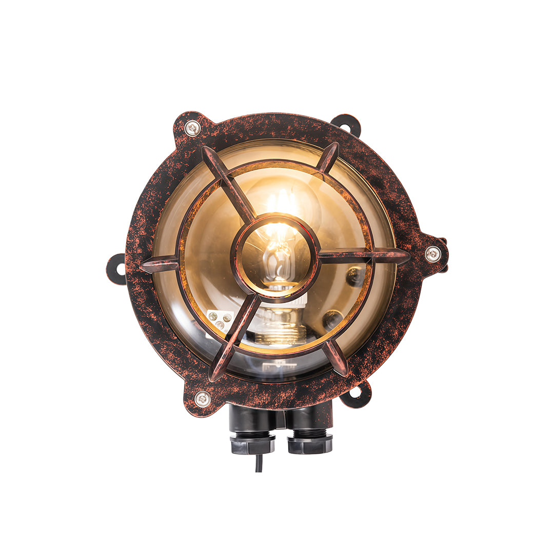 Circular industrial outdoor sconce with porthole-style design and protective metal grid over glass lens