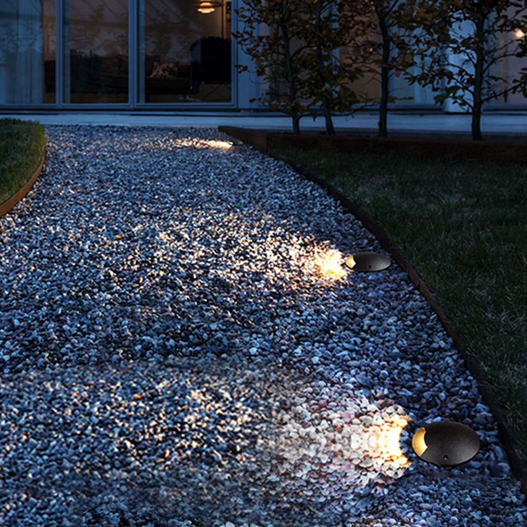 Close-up view of black cylindrical ground fixture showing precision-engineered directional design