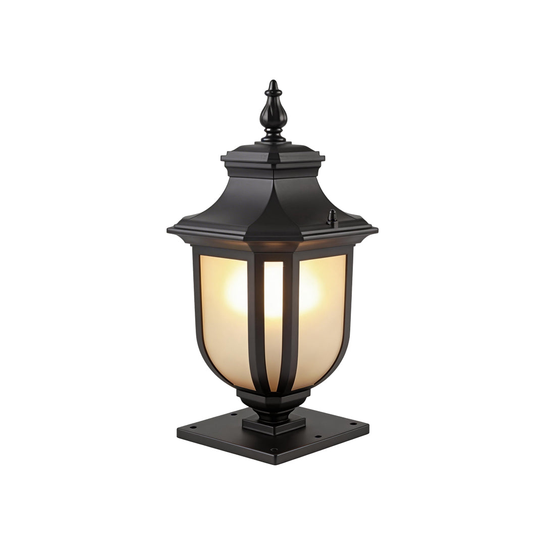 The elegant black vintage outdoor pillar lantern with warm frosted glass on white studio wall.
