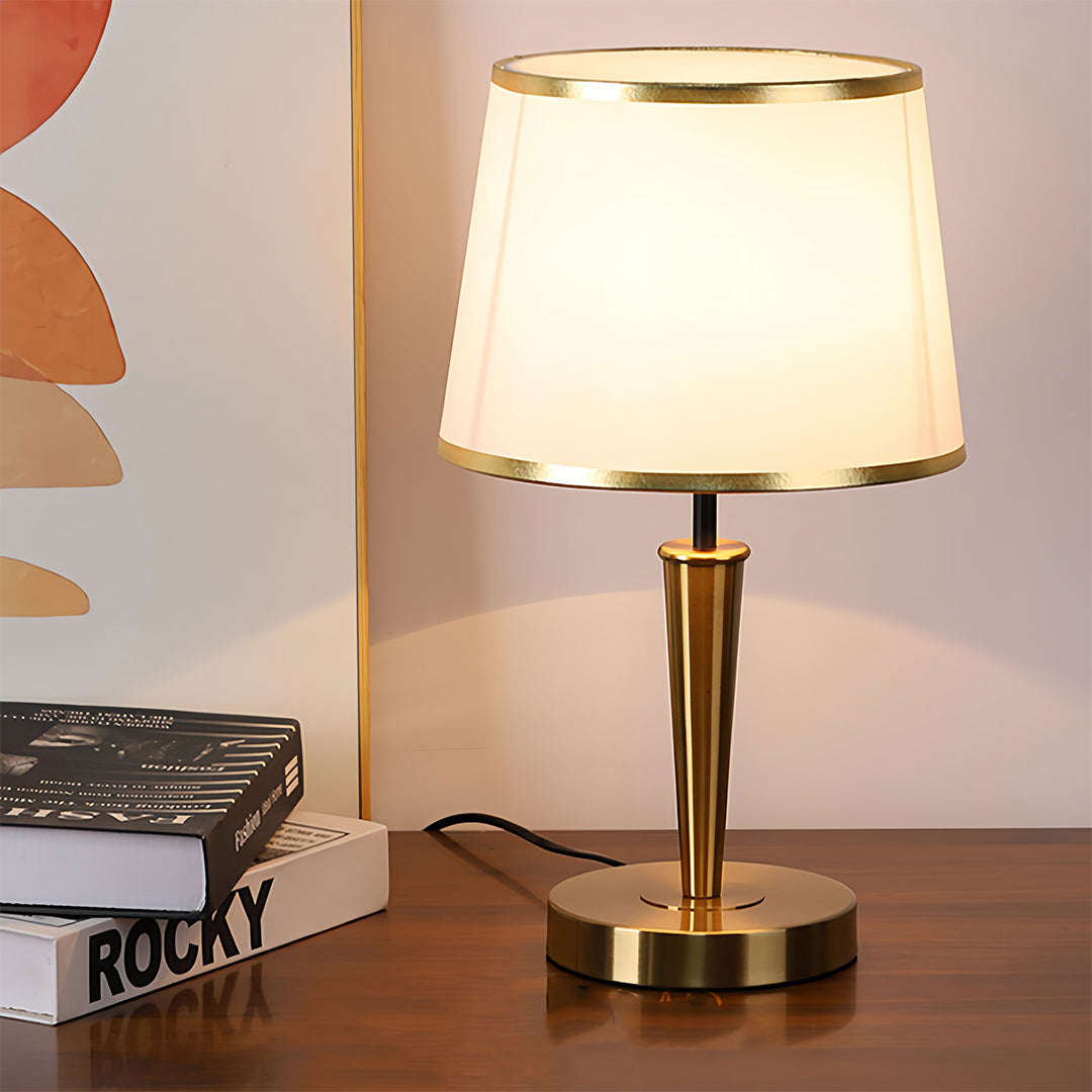 Classic brass table lamp with clean white shade in elegant interior design