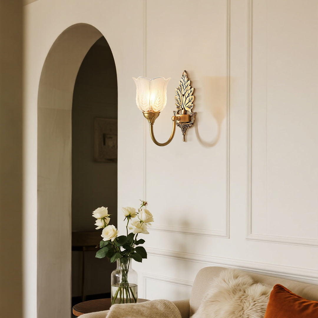 Classic brass wall light illuminating sophisticated hallway with arched doorway design