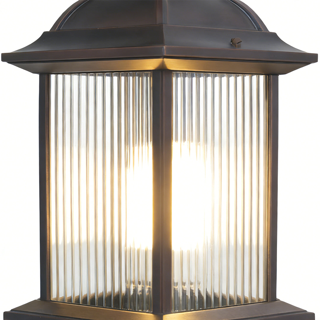 Classic LED post light with clear ribbed glass panels and bronze finish, providing warm illumination for driveways and pathways.