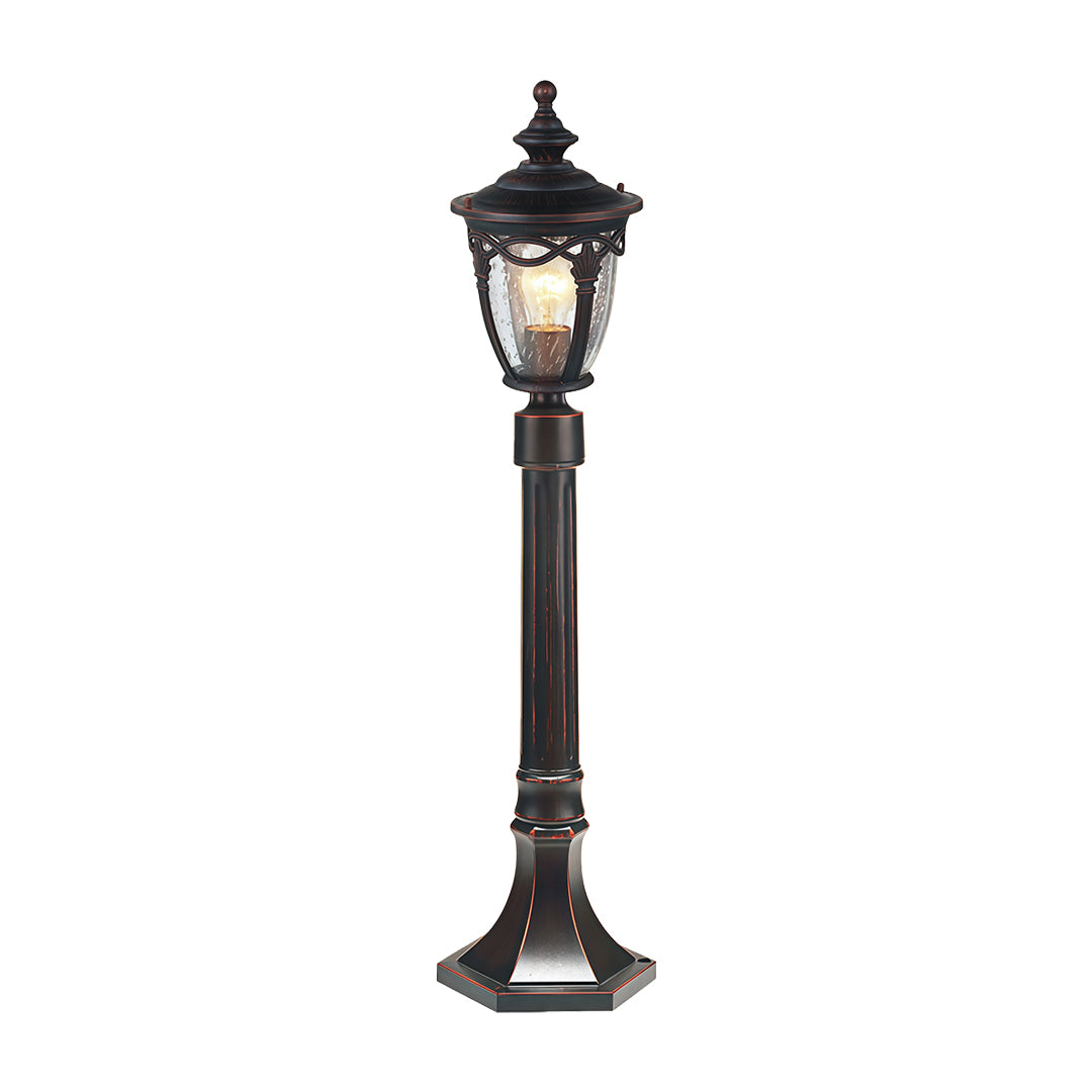 Classic outdoor light bollard featuring decorative top and amber glass on white background
