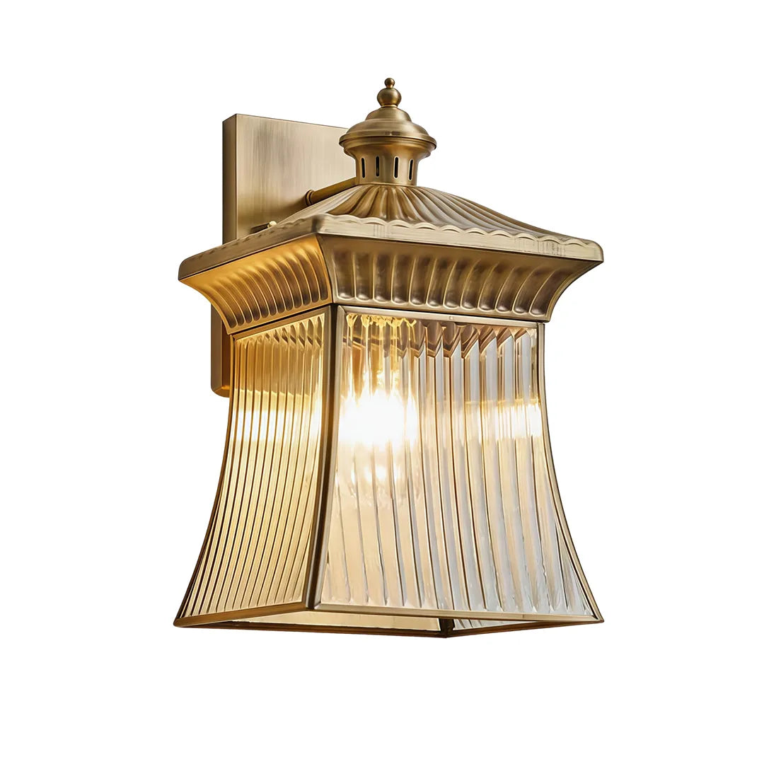 Classic outdoor wall lantern with brass finish and illuminated ribbed glass