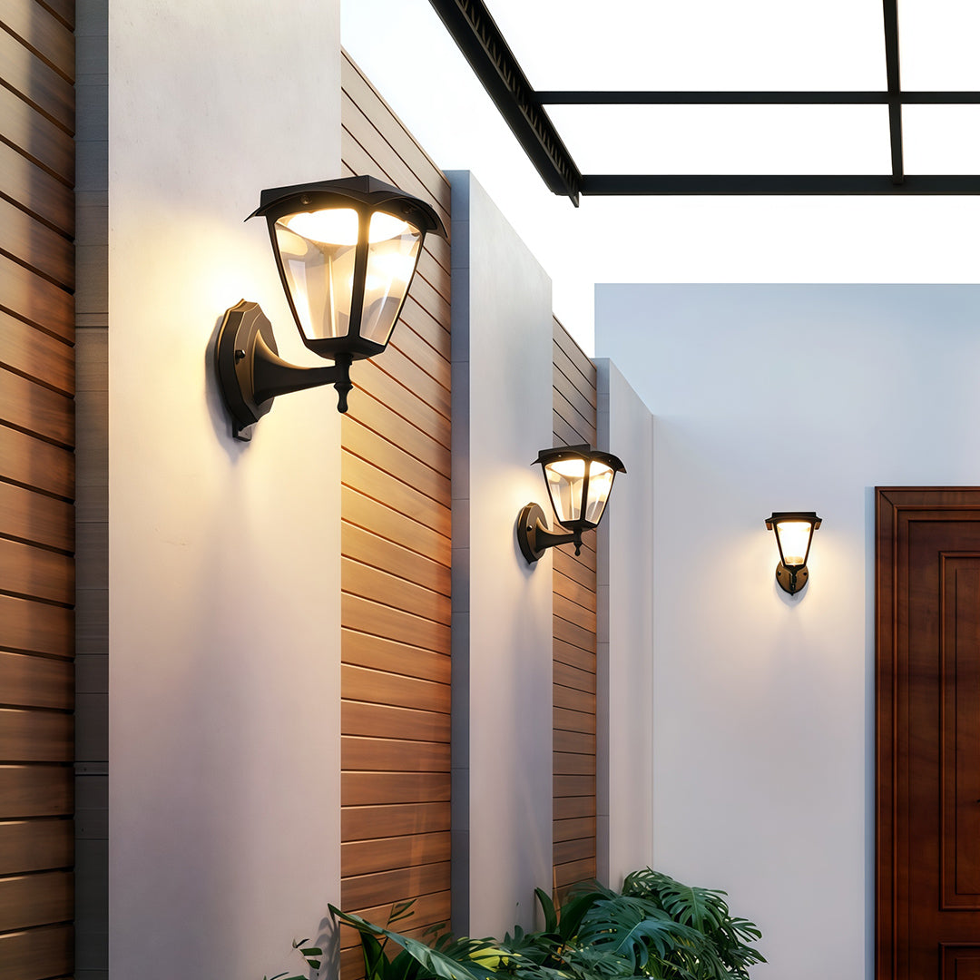 Classic outdoor wall lighting black fixtures illuminating a modern entryway with wood-slat accent walls.