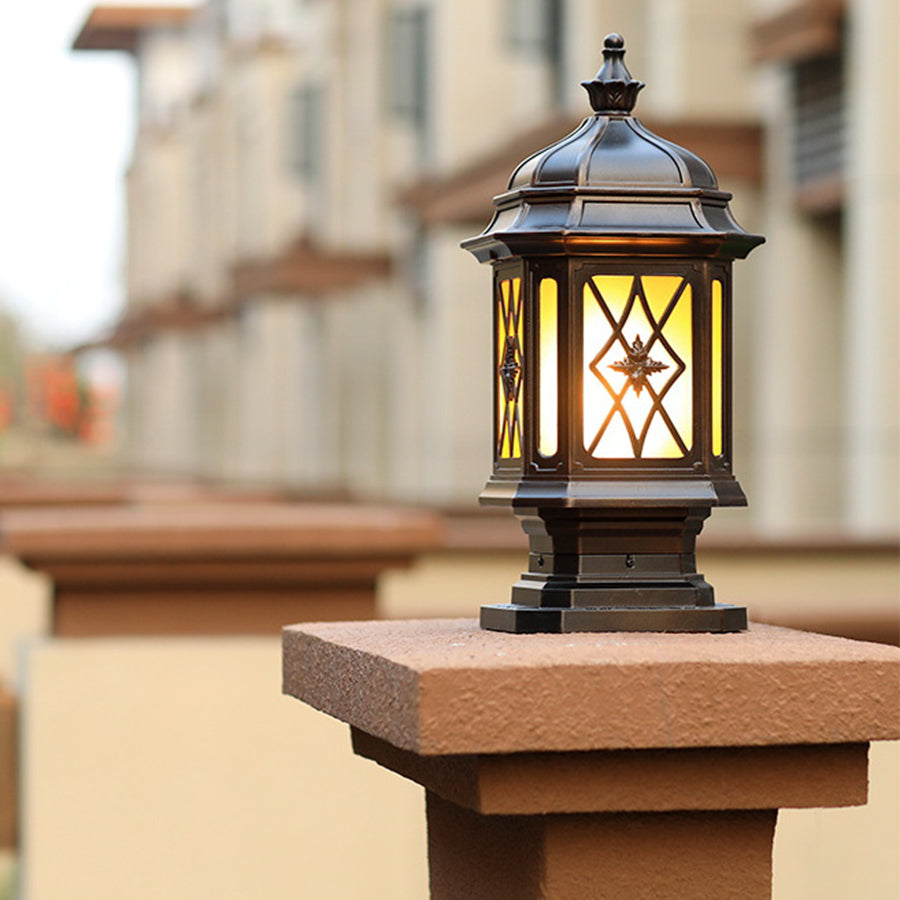 Classic outside pillar light with ornate metal framework installed on wooden post for traditional outdoor lighting