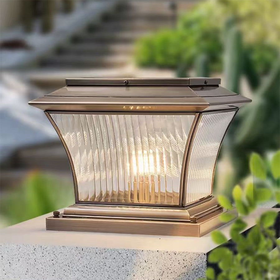 Classic pillar lantern with ribbed glass panels and antique bronze finish on the post