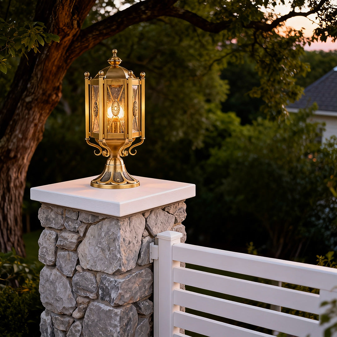 Classic vintage pillar lights mounted on a stone pillar, enhancing the charm of a tropical garden.