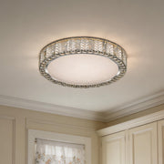 The modern gold flush mount ceiling light shines brightly in a classic white ceiling setting.