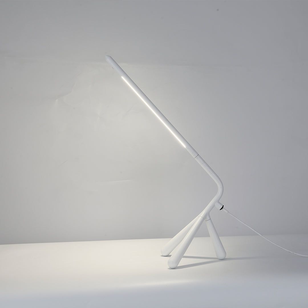 Clean white three legged table lamp with modern aesthetic perfect for contemporary home decor