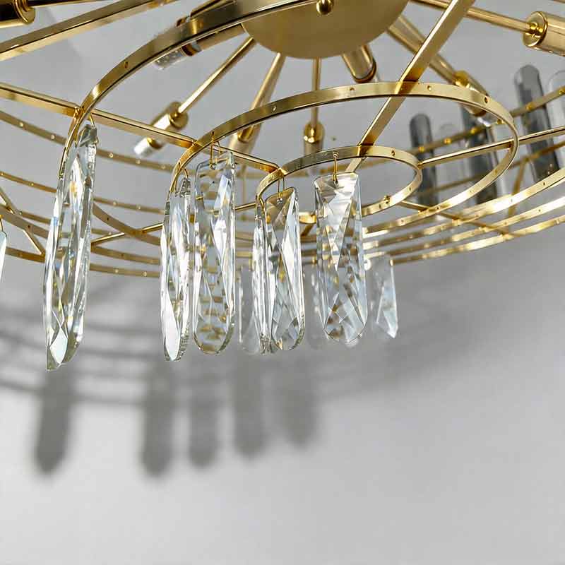 Detail view of clear glass droplets hanging from the round drum crystal chandelier​ gold frame.