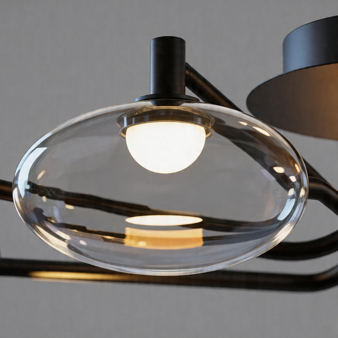 Close-up of clear glass globe shade with visible bulb in a modern ceiling light fixture.