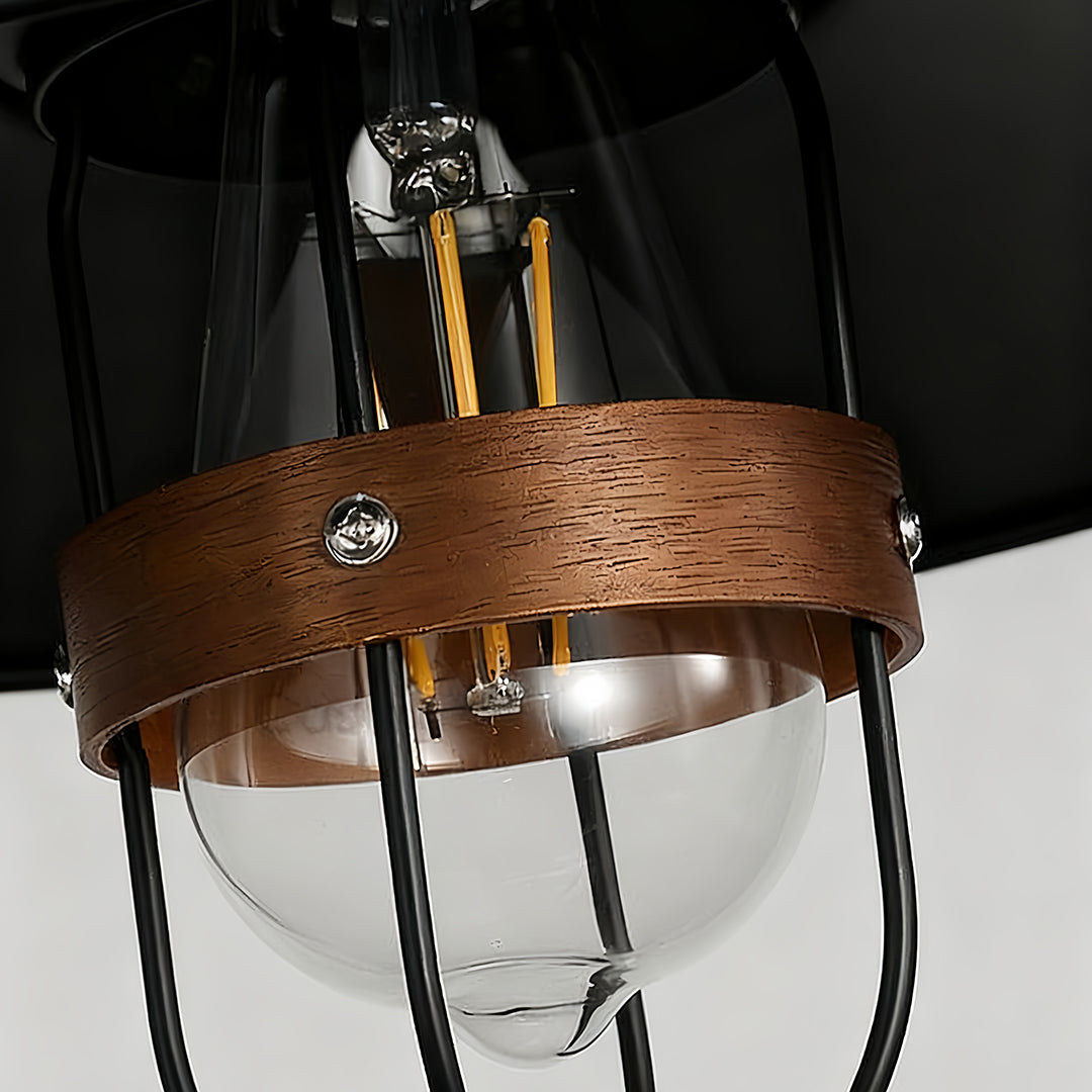 Close-up of clear glass globe on vintage hanging pendant lights with wood accent ring 