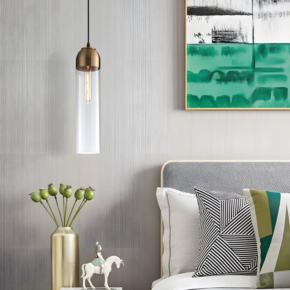 Clear glass Gold Frosted Cylinder Pendant light by an abstract green painting in a bedroom.