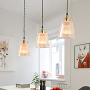 Clear glass pendant lights installed over kitchen island providing functional task lighting