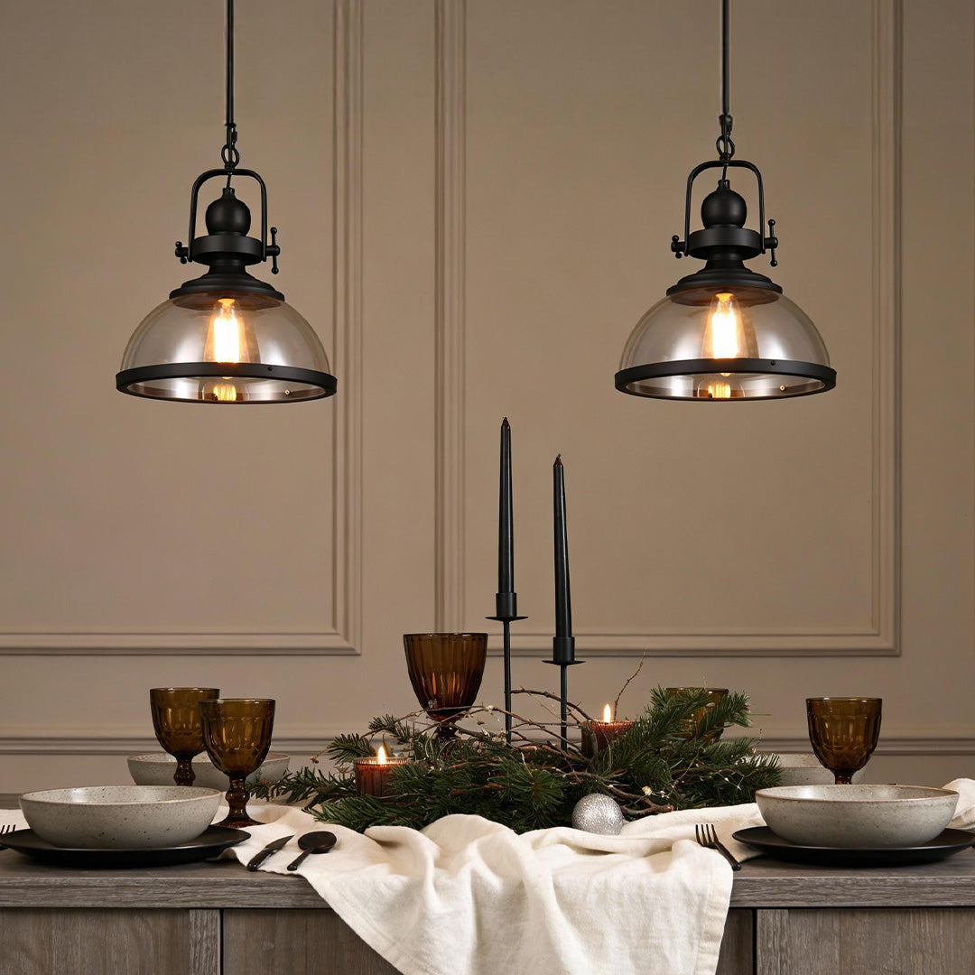 Clear glass pendant lighting hanging above a dining table