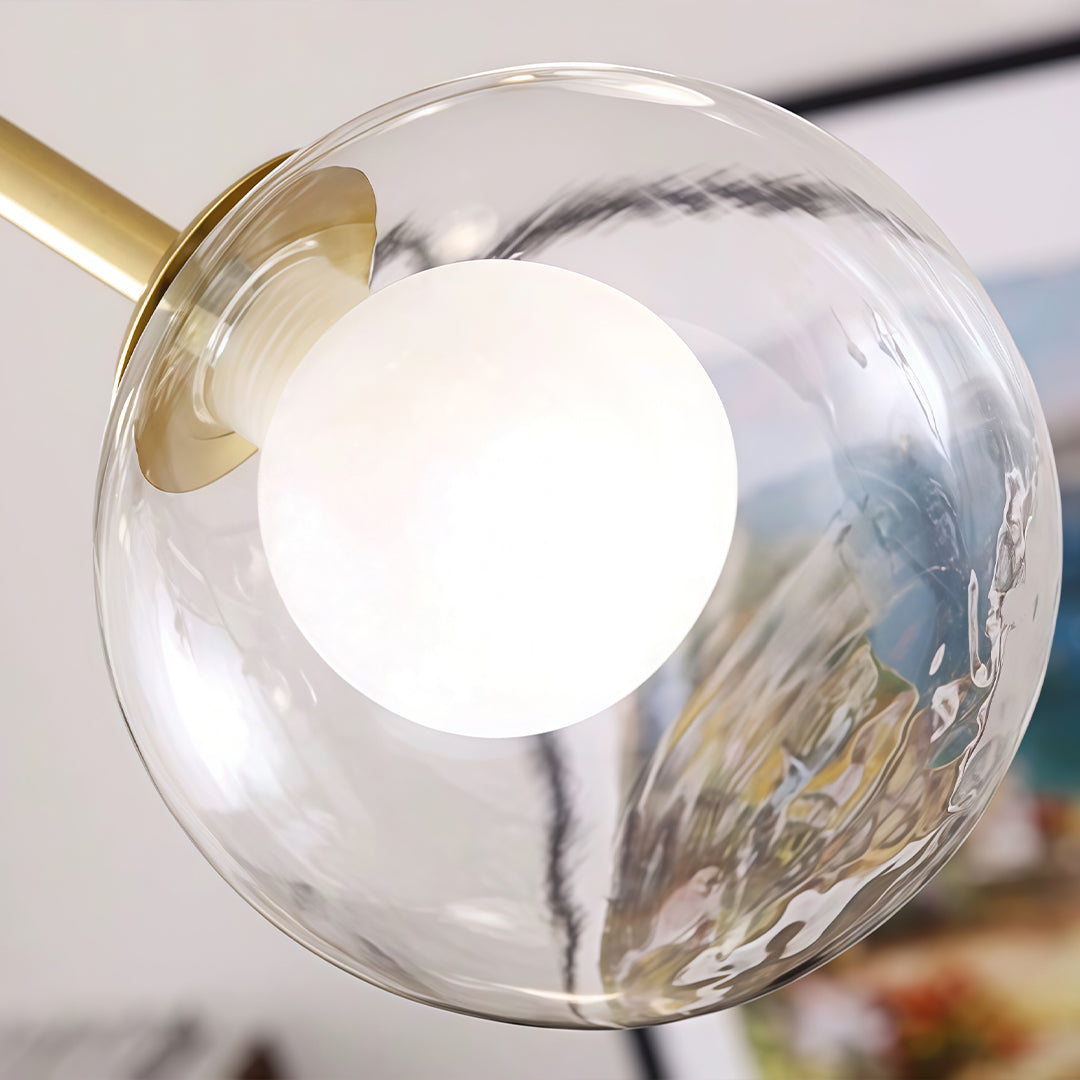 Detailed view of clear glass globe bulb used in a modern glass sputnik light design.