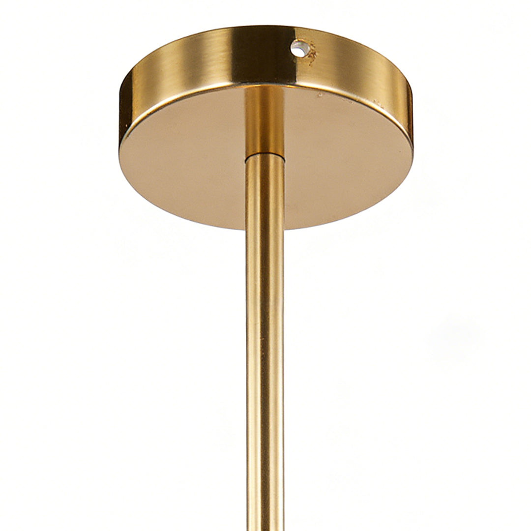 Clear globe pendant light with brushed brass ceiling mount and slim downrod, showing modern hardware detail and elegant glass design.