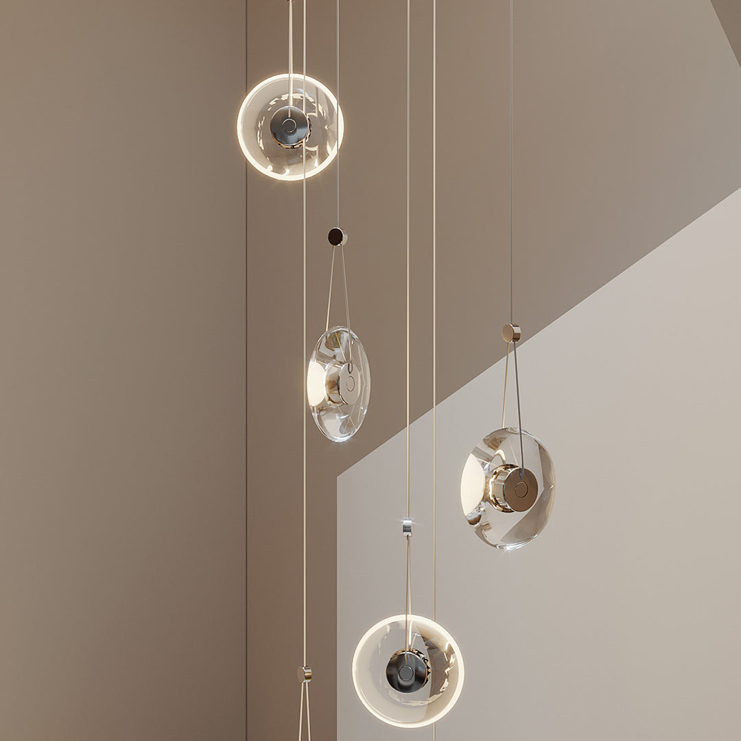Close-up shot of a large clear pendant light showing glass texture and chrome detail.