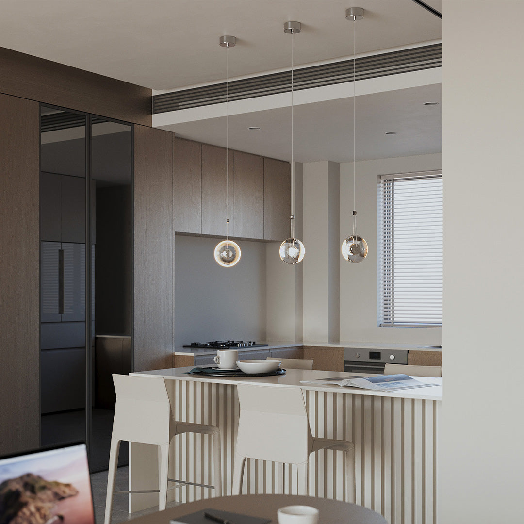 Cluster of clear pendant lights cascading down a stairwell with elegant ambiance.