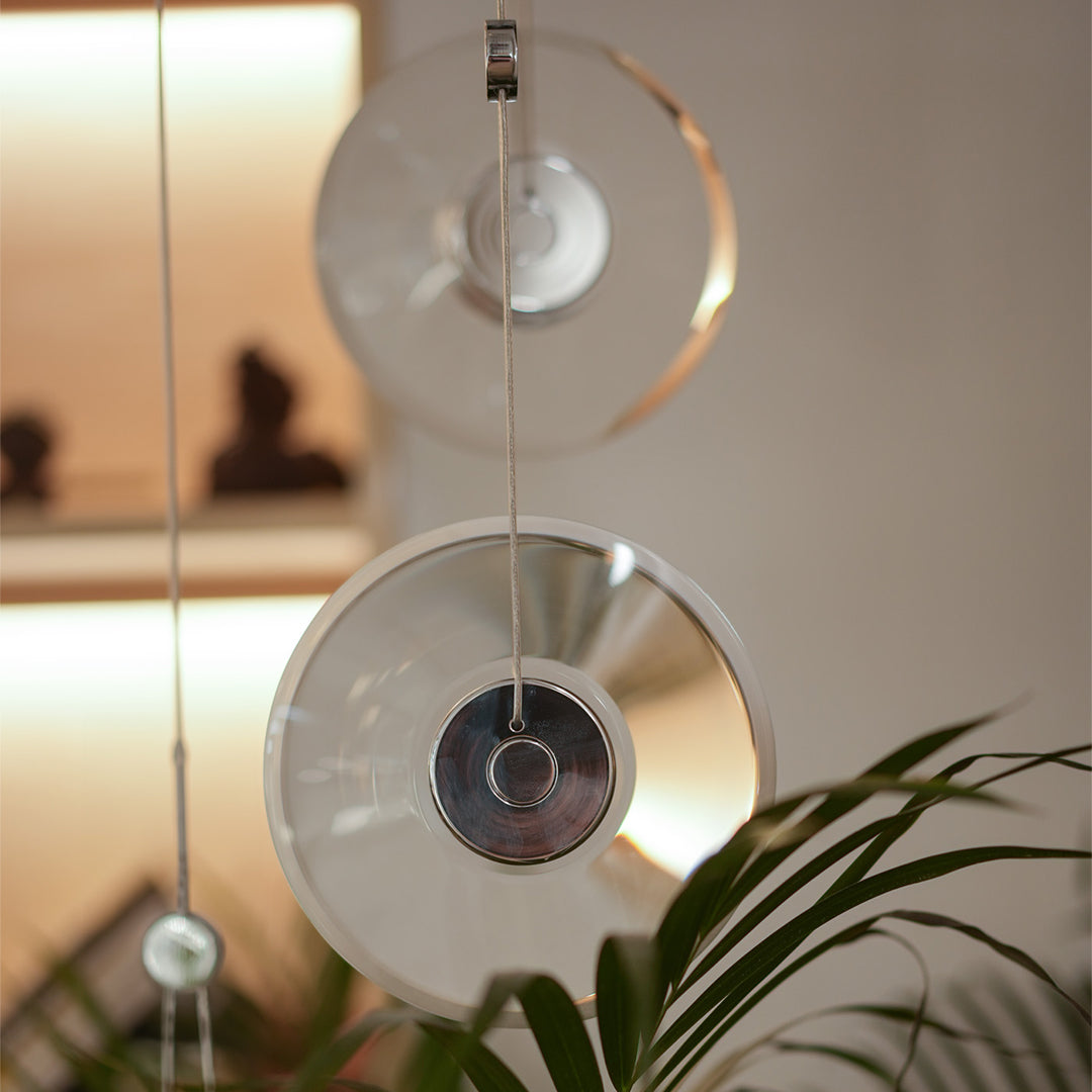 Clear pendant light with pivoting inner led ring creates dynamic lighting and a sleek modern focal point for contemporary interiors.