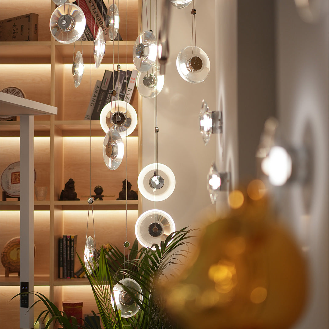 Two-tiered clear pendant lights creating a soft glow in a modern interior.