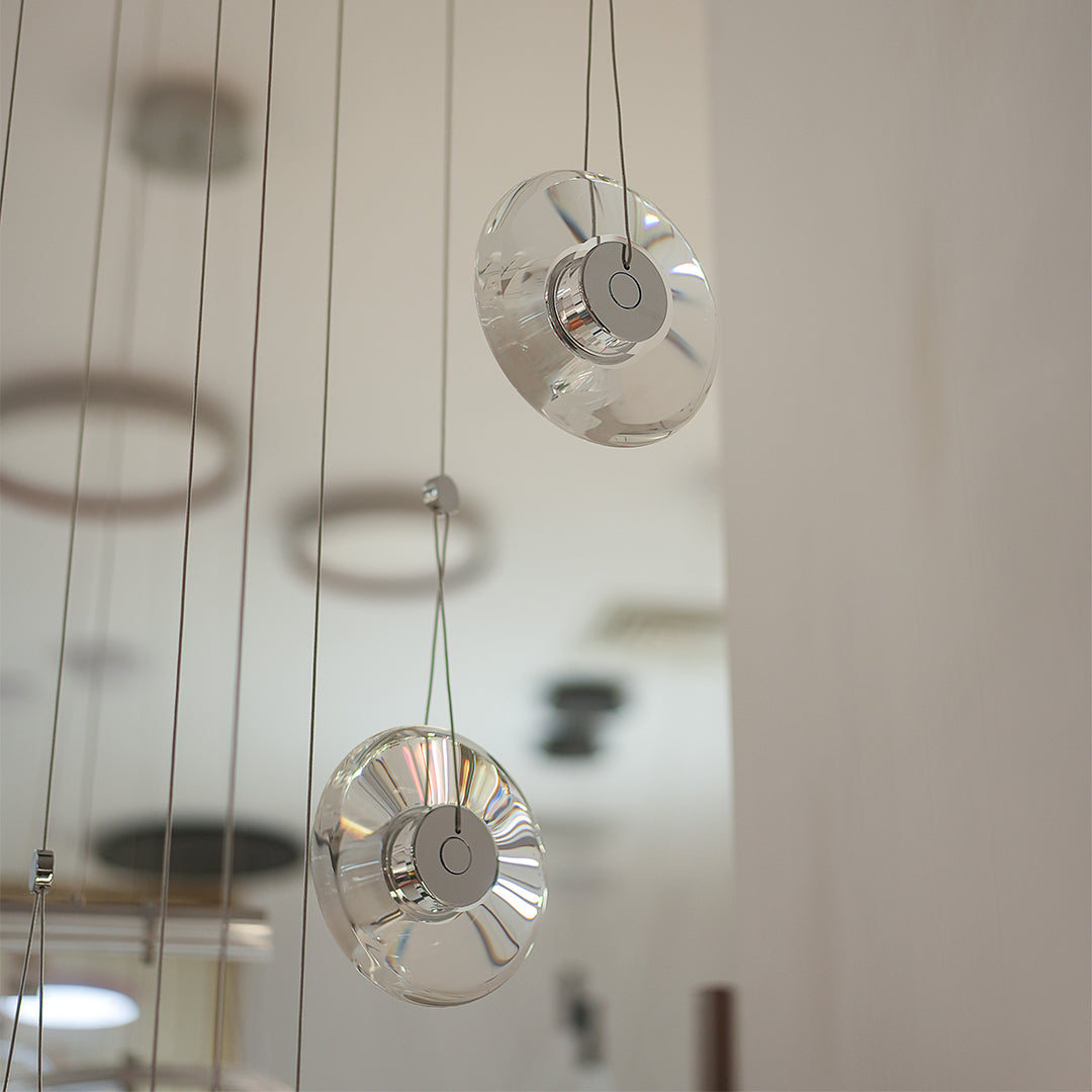Two-tiered clear pendant lights creating a soft glow in a modern interior.