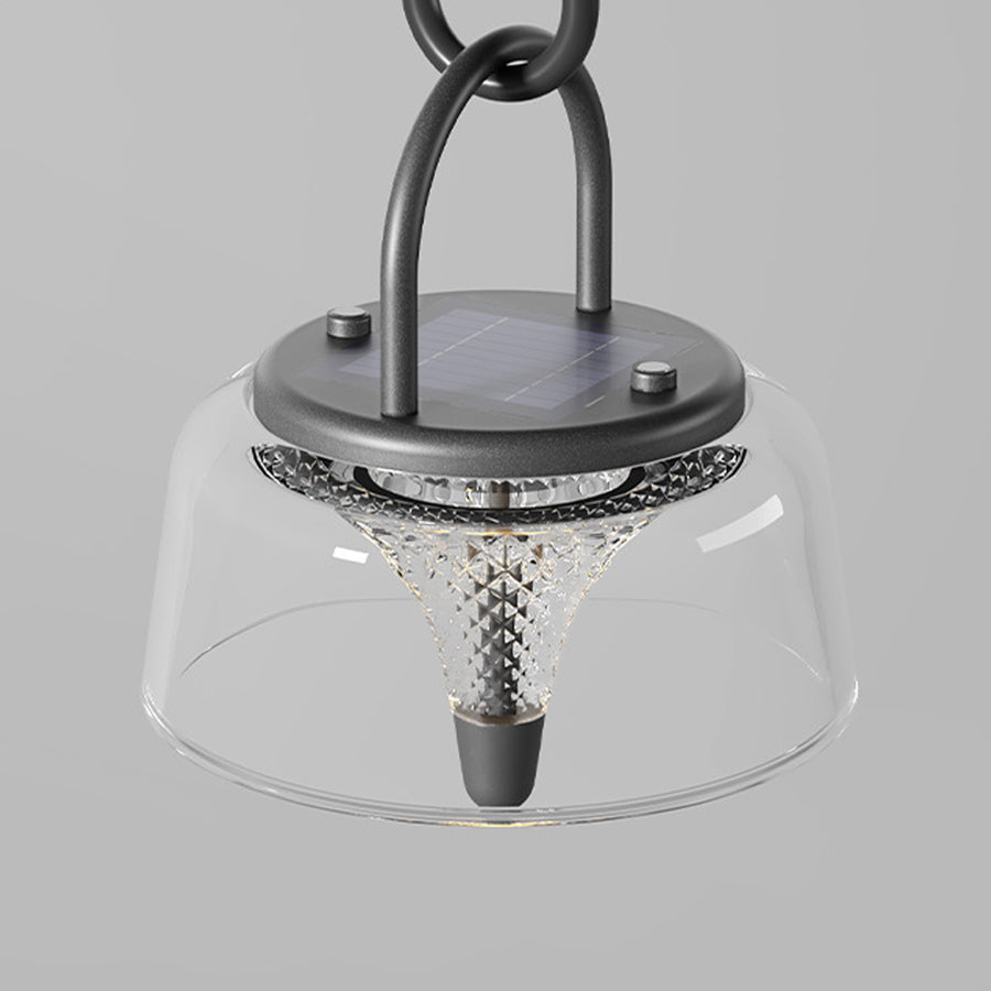 Clear pendant lights hanging from a black cord, adding a contemporary touch to outdoor spaces.